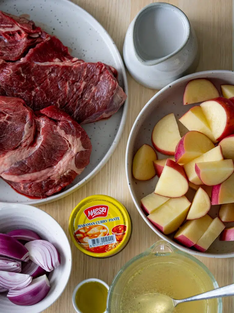 Raw ingredients for Massaman beef curry laid out before cooking