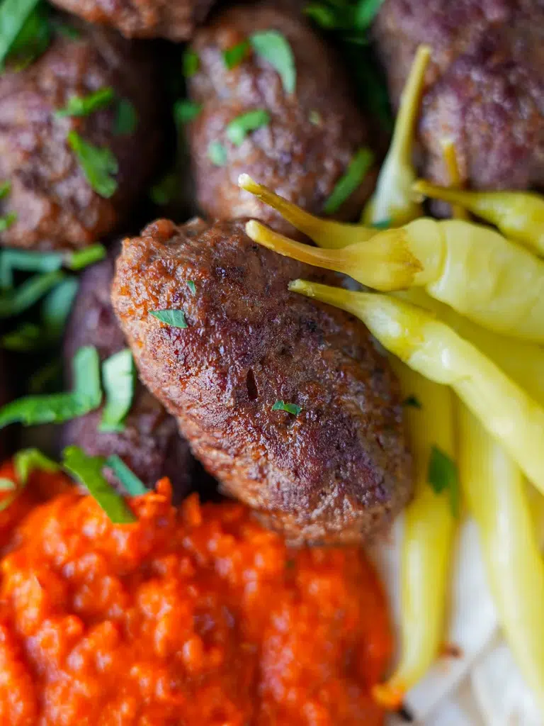 Close-up of homemade beef cevapi with onions and soft pita bread