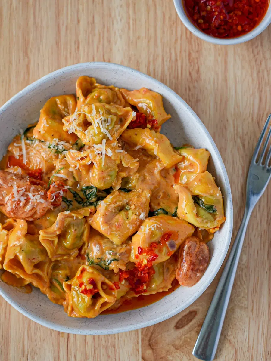 A Bowl of One pan of Spinach & Ricotta Tortellini with Creamy Tomato Sauce Recipe with fork