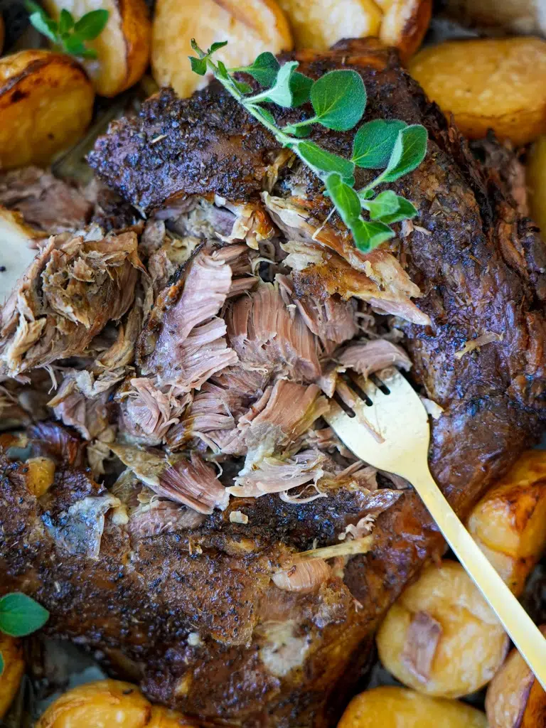 Close-up of Slow Cooker Lamb Shoulder with a focus on the tender, succulent meat and vegetables