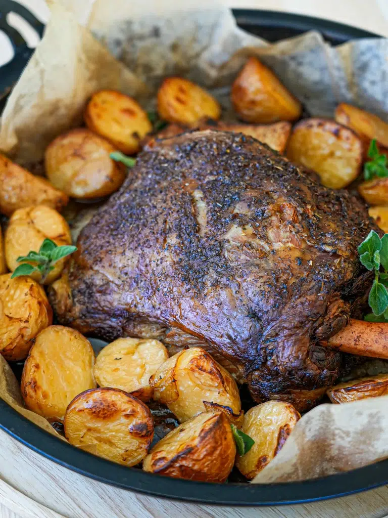Delicious Slow Cooker Lamb Shoulder with vegetables, garnished and ready for serving