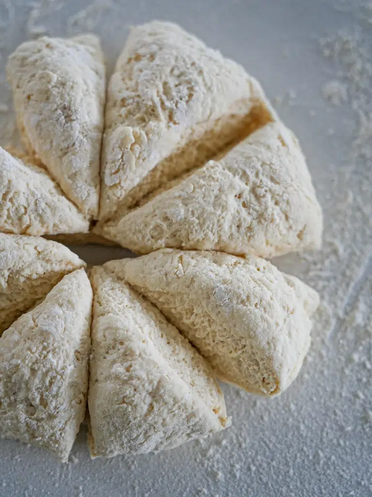 Uncooked flatbread dough wedges, ready for cooking.