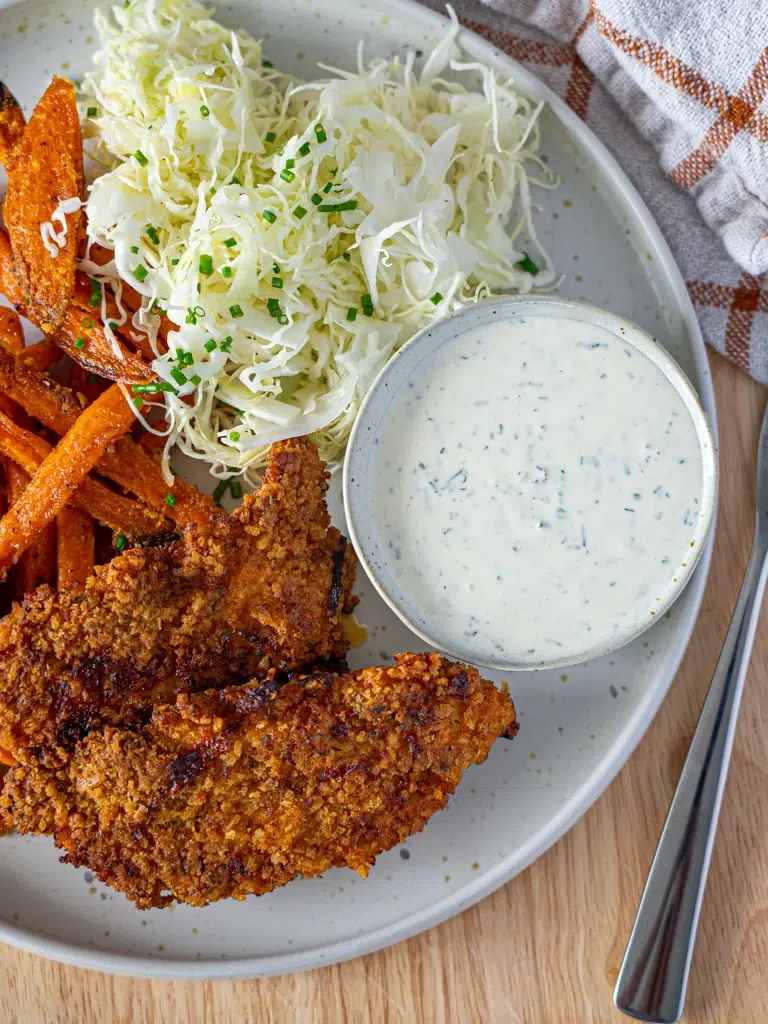 Homemade ranch dipping sauce served with fries and Southern-style baked chicken strips