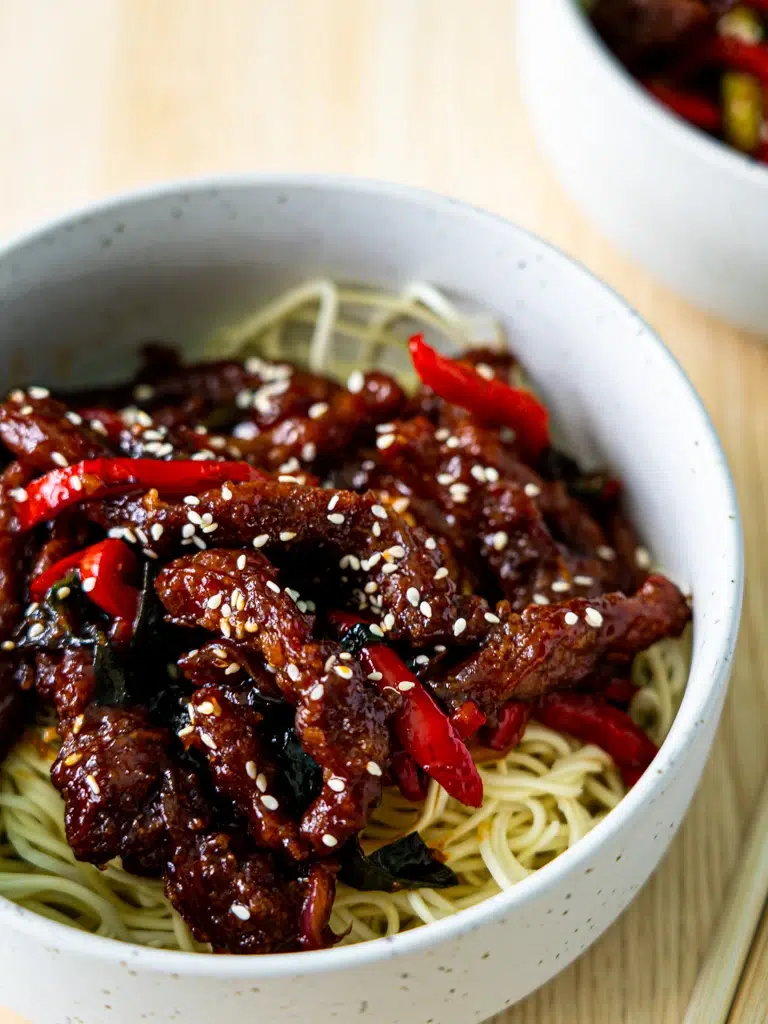 Side view of two servings of Sticky Rainbow Beef in bowls