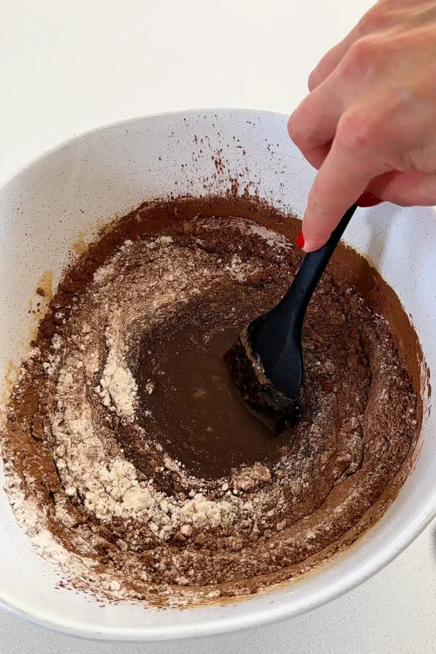 Dry ingredients added into butter mixture, partially mixed together