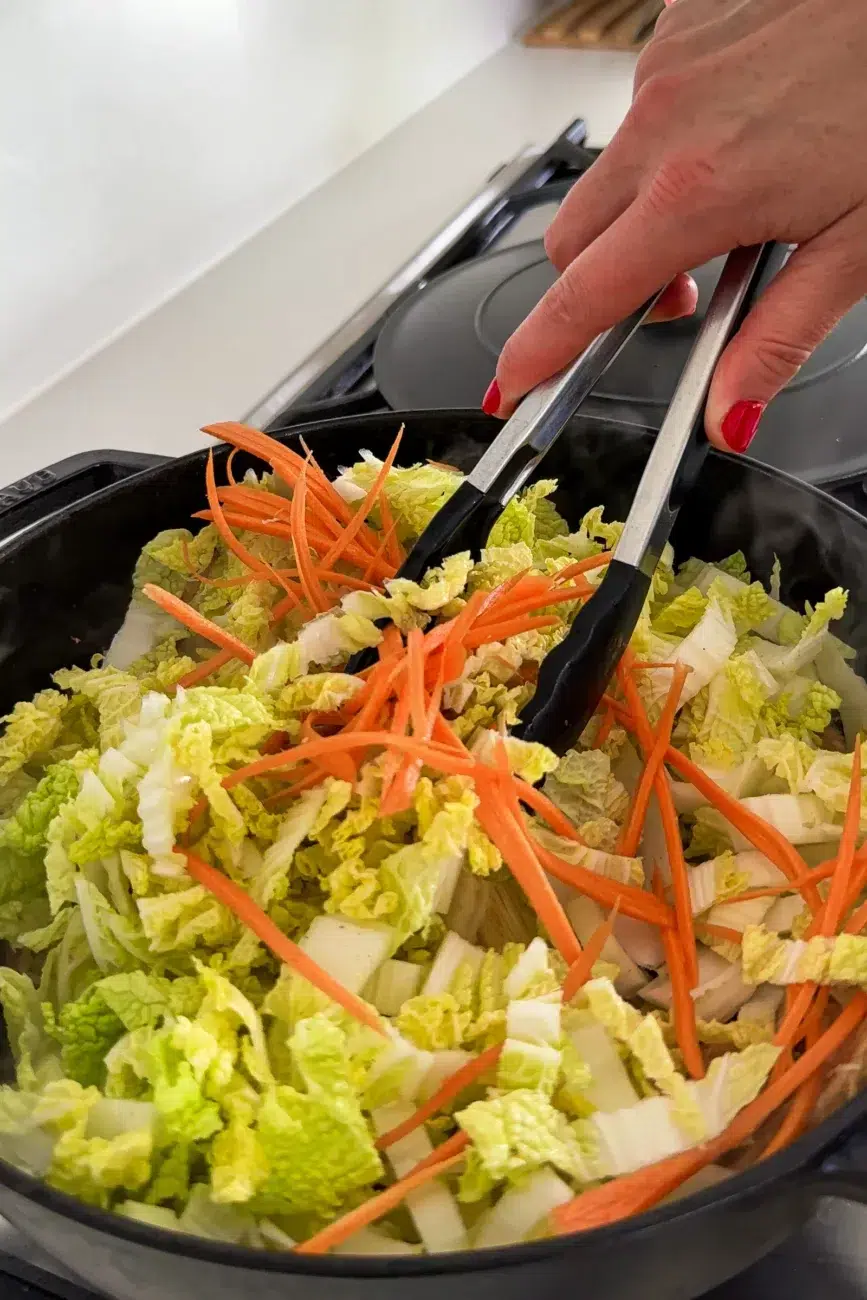 Wombok cabbage and carrot added to pan