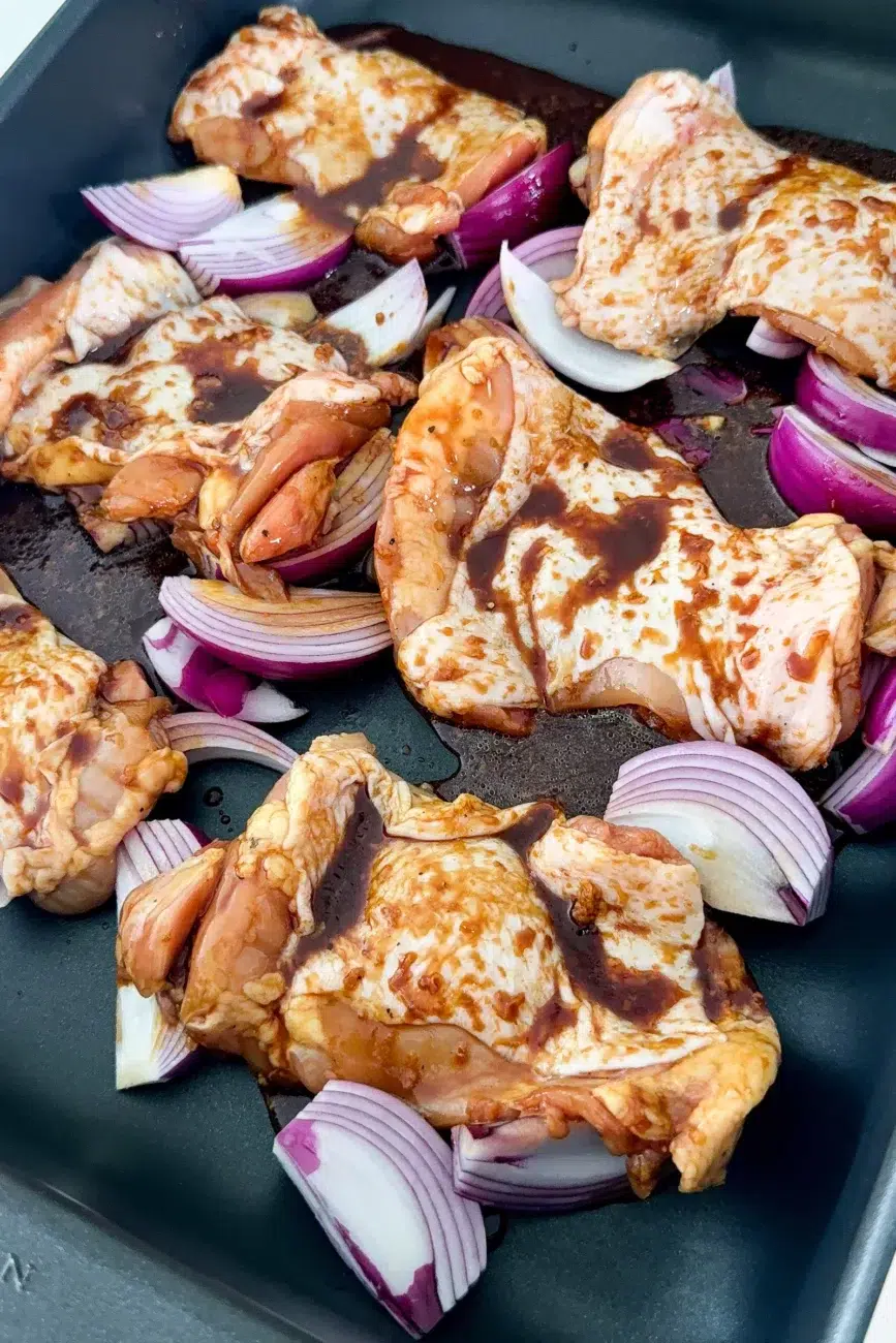 Chicken and red onion in tray honey soy chicken marinade