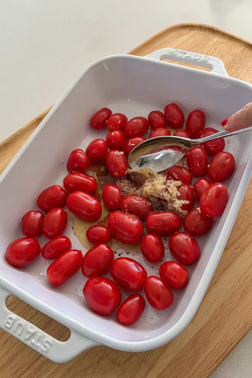 Jammy tomatoes mixed in baking dish