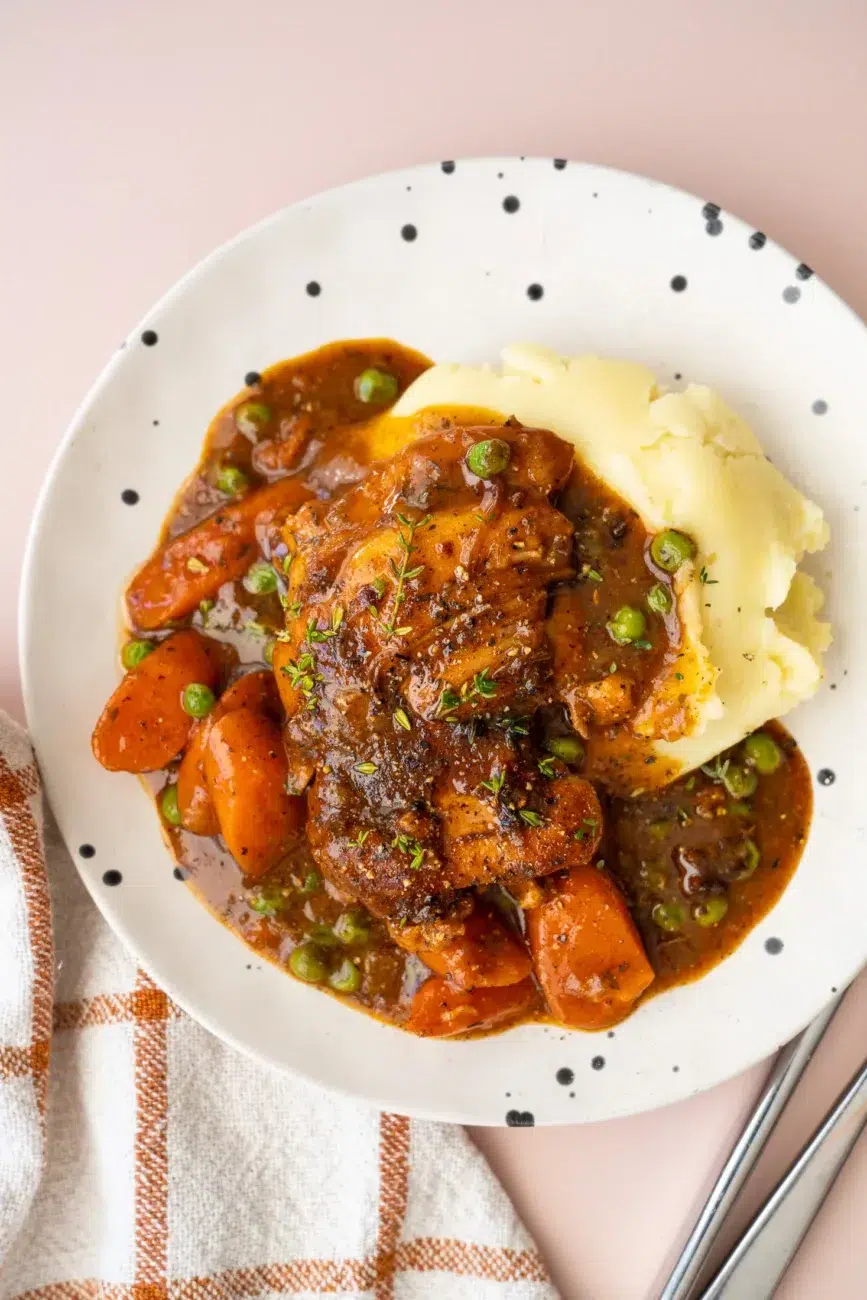 Finished carrots chicken and gravy plated top view served with mashed potatoes