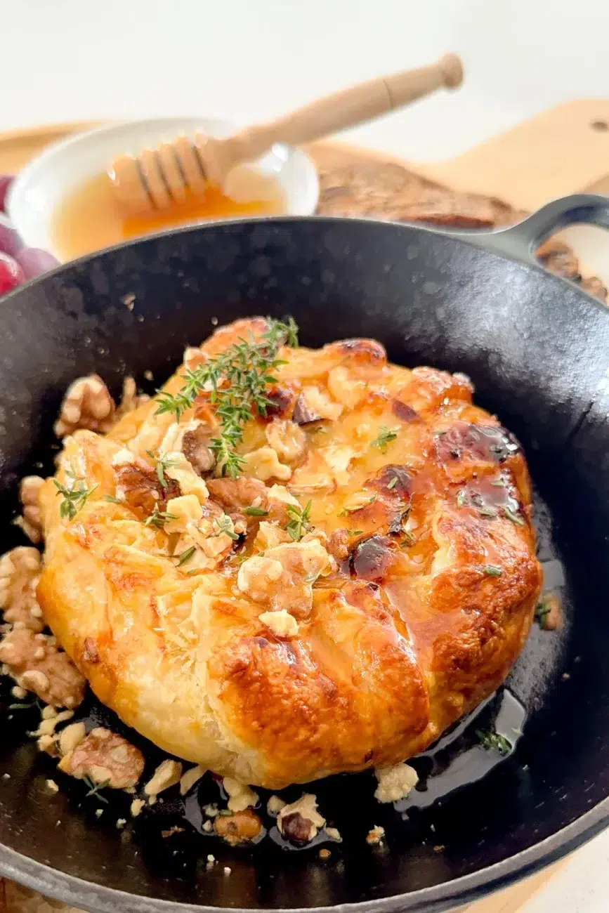 Baked Brie on serving platter with honey and bread
