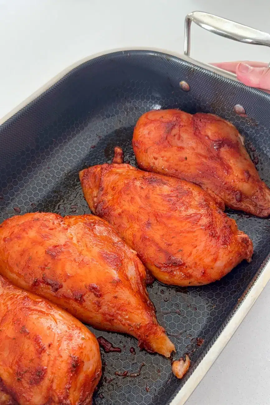 Marinated whole chicken breast ready for oven