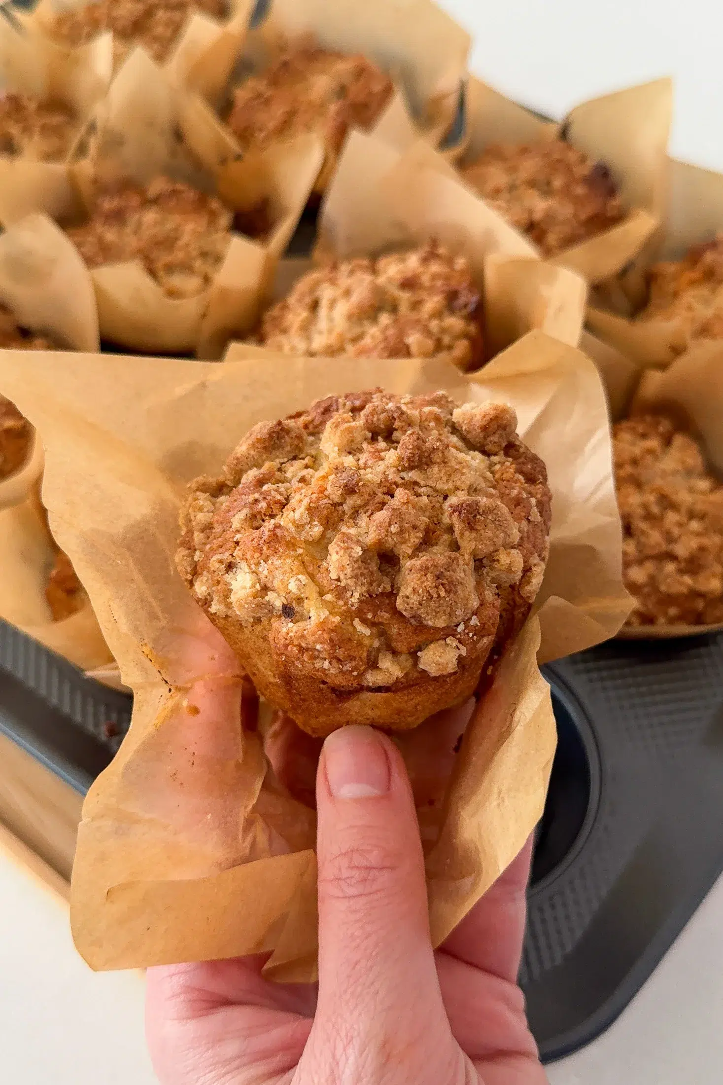The finished Apple Cinnamon Muffin being held in hand