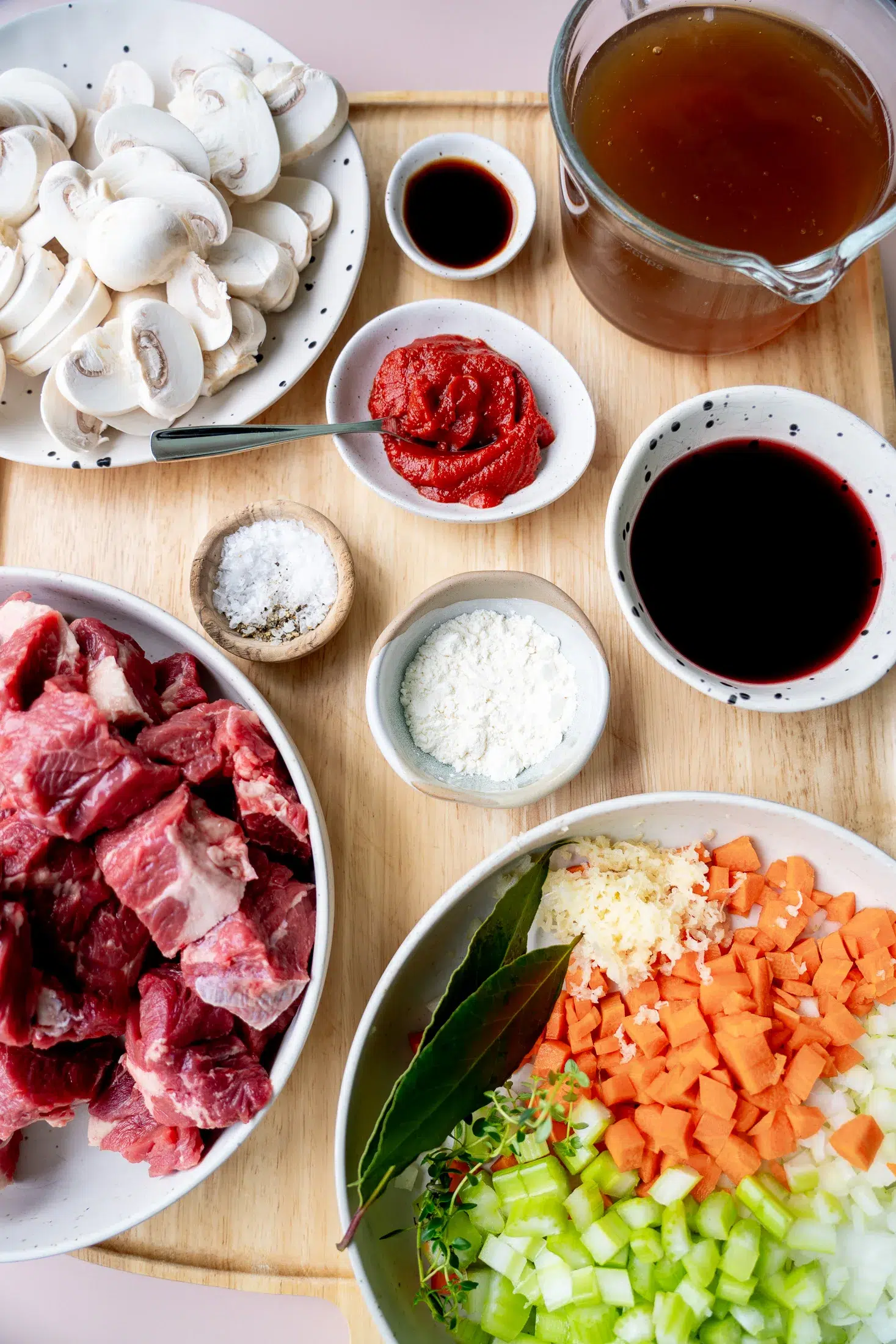 Slow-cooked beef and mushroom ragu recipe ingredients laid out on a bench