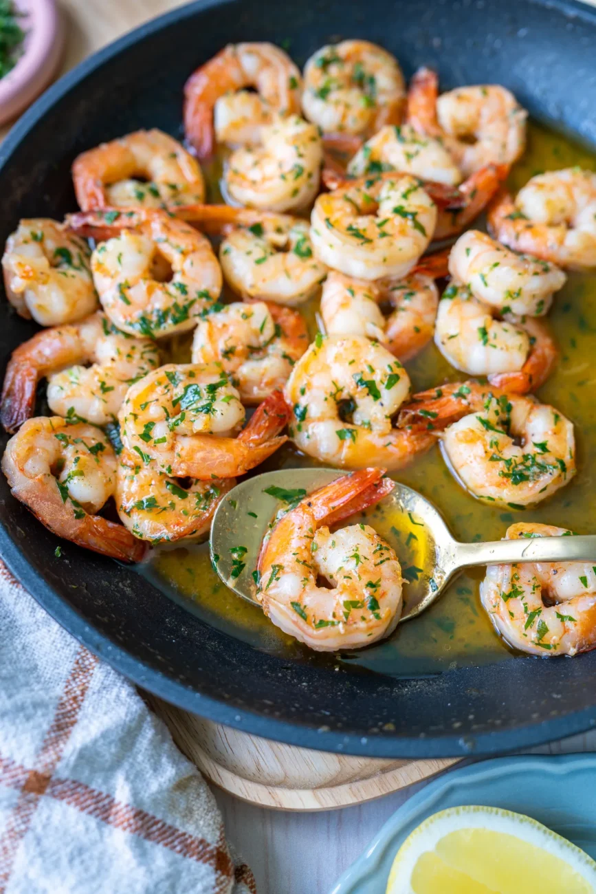 Prawns in pan with spoon digging in